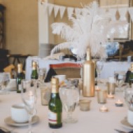 Feather centerpieces with wine bottle. Great Gatsby Bridal Shower. Bridesmaidsconfession.com